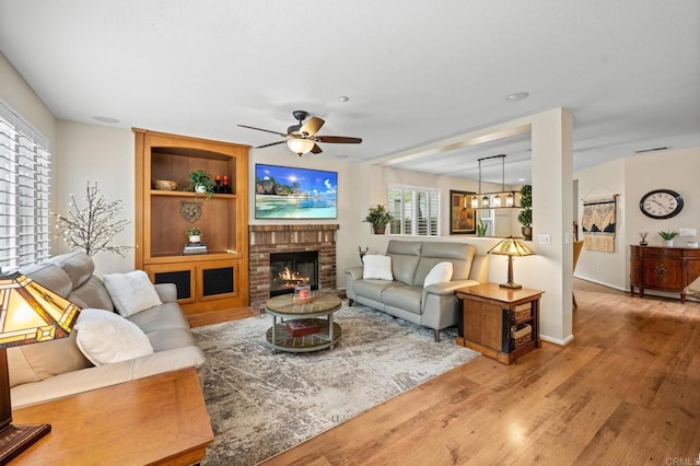 1752 Cottonwood Dr, Vista, CA 92081 - living area with a ceiling fan, wood finished floors, a fireplace, and baseboards