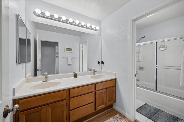 1752 Cottonwood Dr, Vista, CA 92081 - bathroom with combined bath / shower with glass door, double vanity, and a textured wall