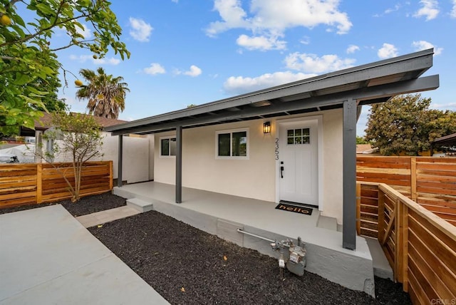 exterior space with fence and stucco siding
