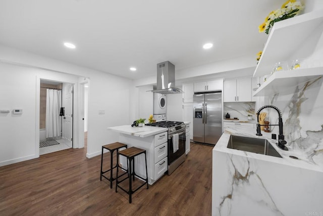 kitchen featuring a sink, dark wood-style flooring, appliances with stainless steel finishes, and extractor fan