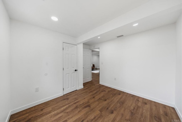 unfurnished bedroom featuring visible vents, recessed lighting, baseboards, and wood finished floors