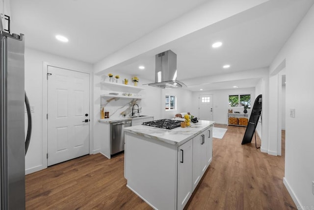 kitchen with appliances with stainless steel finishes, white cabinets, dark wood-style floors, and island exhaust hood