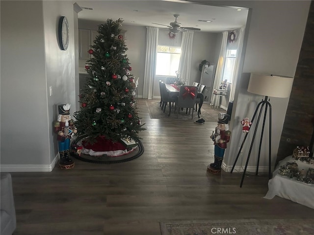 dining area with baseboards, ceiling fan, wood finished floors, and visible vents