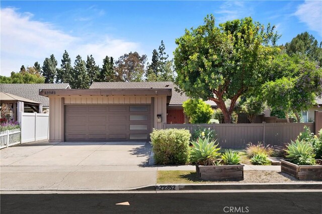 22352 Torino, Laguna Hills, CA 92653 - view of front of house featuring fence, board and batten siding, and concrete driveway