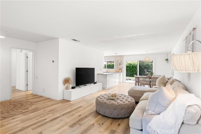 22352 Torino, Laguna Hills, CA 92653 - living area with light wood-style flooring and baseboards