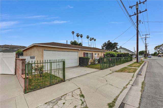 1302 S Gladys Ave, San Gabriel, CA 91776 - ranch-style house with stucco siding, a gate, driveway, an attached garage, and a fenced front yard