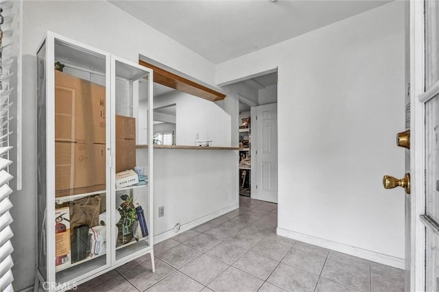 1302 S Gladys Ave, San Gabriel, CA 91776 - tiled empty room featuring baseboards
