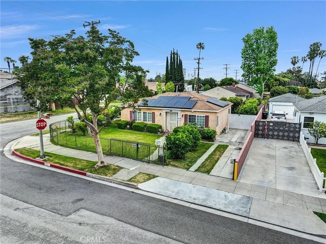 1302 S Gladys Ave, San Gabriel, CA 91776 - view of front of property featuring solar panels, concrete driveway, stucco siding, and a gate