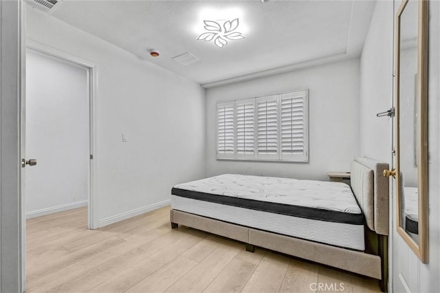 1302 S Gladys Ave, San Gabriel, CA 91776 - bedroom with light wood-type flooring and baseboards
