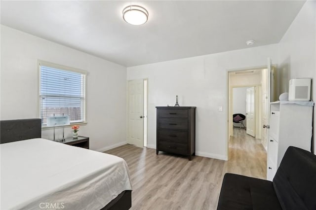 bedroom featuring baseboards and light wood-style floors