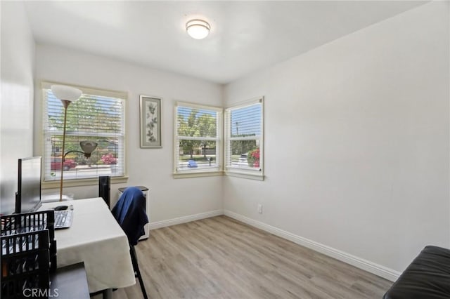 office featuring baseboards and wood finished floors