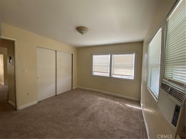 3755 Brockton Ave Unit 1-4, Riverside, CA 92501 - unfurnished bedroom featuring a closet, baseboards, cooling unit, and carpet flooring