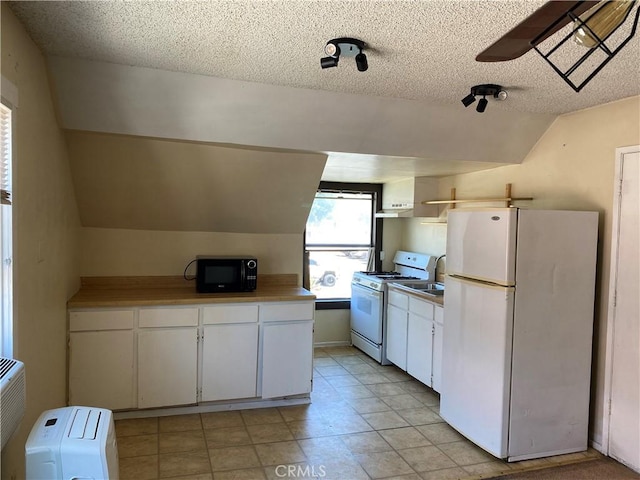 3755 Brockton Ave Unit 1-4, Riverside, CA 92501 - kitchen featuring a textured ceiling, lofted ceiling, white cabinets, and white appliances