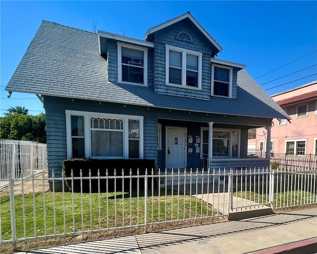 3755 Brockton Ave Unit 1-4, Riverside, CA 92501 - view of front of house featuring covered porch, a fenced front yard, and a front lawn