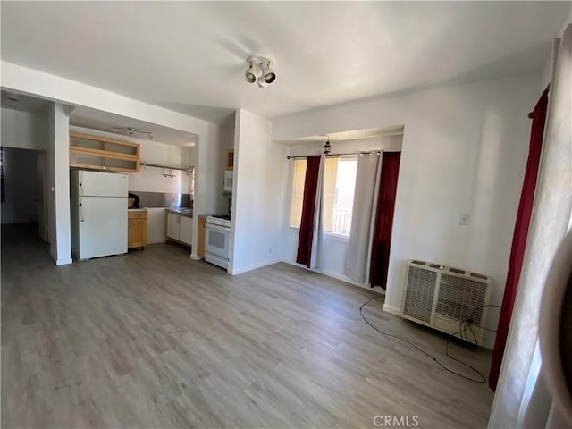 3755 Brockton Ave Unit 1-4, Riverside, CA 92501 - unfurnished living room featuring light wood-style floors, baseboards, and a wall mounted AC