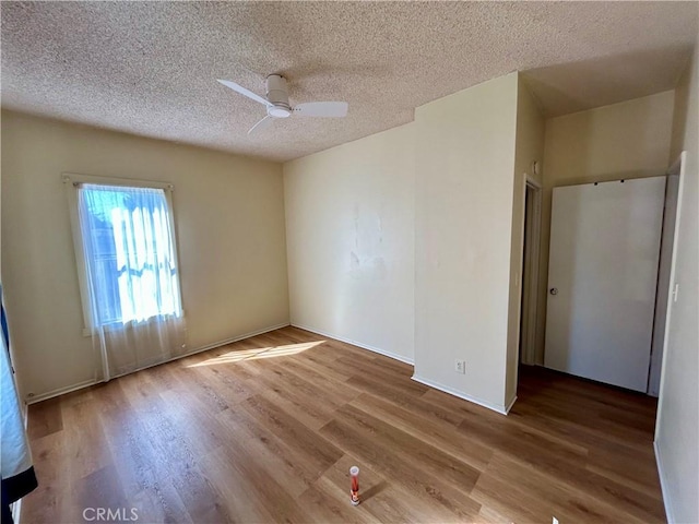 3755 Brockton Ave Unit 1-4, Riverside, CA 92501 - spare room with baseboards, a ceiling fan, a textured ceiling, and wood finished floors
