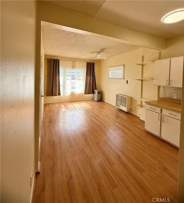 3755 Brockton Ave Unit 1-4, Riverside, CA 92501 - unfurnished living room featuring a textured ceiling and light wood-style flooring