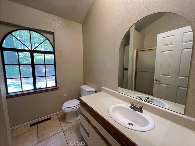 full bath with vanity, visible vents, toilet, tile patterned floors, and a shower with shower door