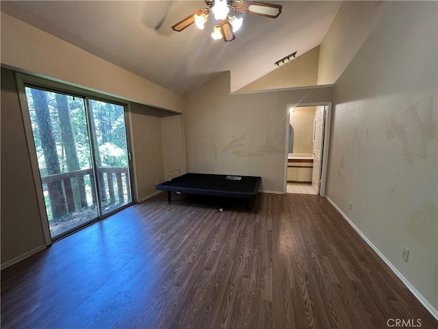 unfurnished living room featuring wood finished floors, a ceiling fan, baseboards, and lofted ceiling