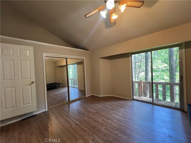 unfurnished bedroom with access to outside, wood finished floors, and vaulted ceiling