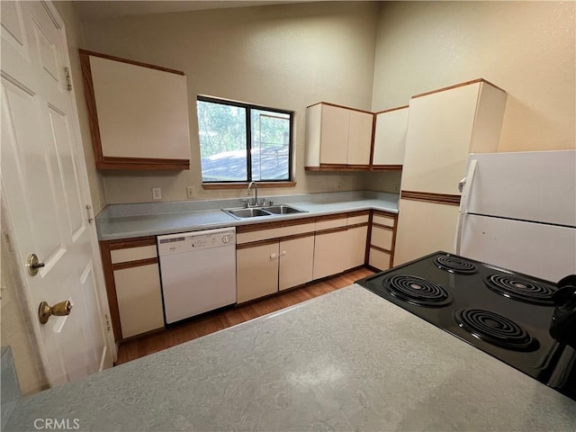 kitchen with a sink, dishwasher, light countertops, light wood-style flooring, and black range with electric cooktop