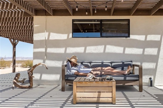exterior space with outdoor lounge area, a mountain view, and a pergola