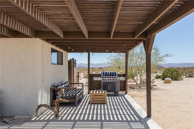 view of patio with a mountain view and a pergola