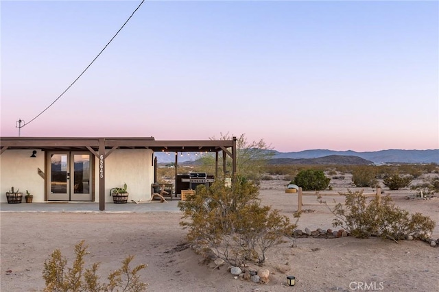 exterior space with stucco siding and a mountain view