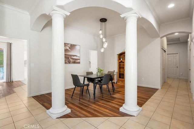 1050 Sleepy Hollow Rd, Paso Robles, CA 93446 - dining area featuring light tile patterned floors, ornate columns, arched walkways, ornamental molding, and baseboards