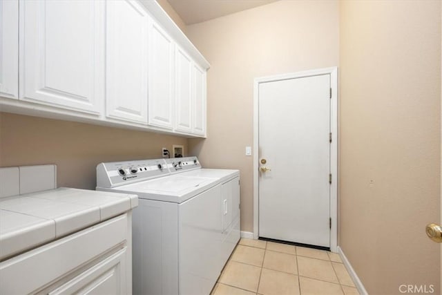 1050 Sleepy Hollow Rd, Paso Robles, CA 93446 - clothes washing area with cabinet space, washer and dryer, light tile patterned floors, and baseboards
