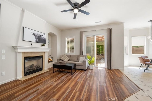 1050 Sleepy Hollow Rd, Paso Robles, CA 93446 - living area featuring ornamental molding, ceiling fan, wood finished floors, a tiled fireplace, and baseboards