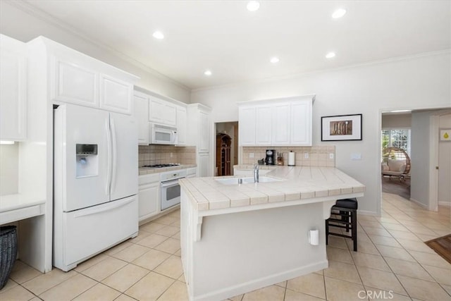 1050 Sleepy Hollow Rd, Paso Robles, CA 93446 - kitchen with white appliances, tile countertops, a sink, crown molding, and light tile patterned floors