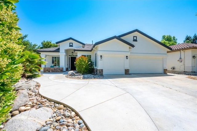 1050 Sleepy Hollow Rd, Paso Robles, CA 93446 - single story home with stucco siding, a garage, concrete driveway, and stone siding