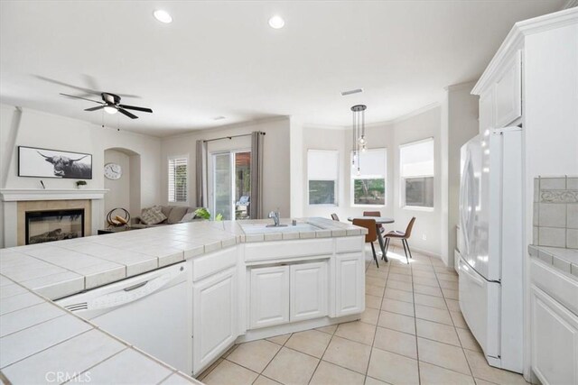 1050 Sleepy Hollow Rd, Paso Robles, CA 93446 - kitchen with white appliances, tile counters, open floor plan, a sink, and light tile patterned floors