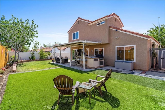 back of house with a patio, a fenced backyard, stucco siding, area for grilling, and a lawn