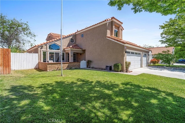 view of front facade featuring fence, a front yard, stucco siding, concrete driveway, and a tile roof