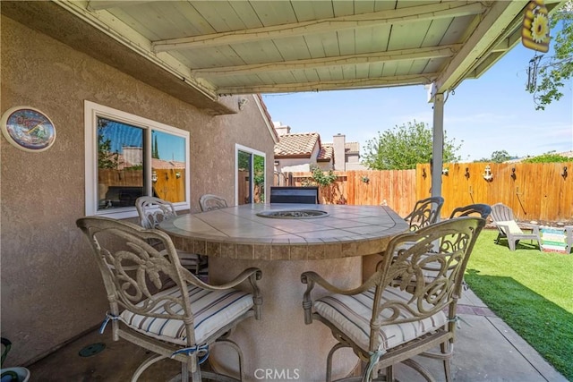 view of patio with a fenced backyard and outdoor dry bar