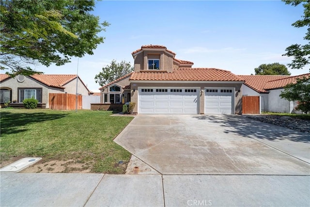 mediterranean / spanish-style house with fence, an attached garage, concrete driveway, and a front lawn