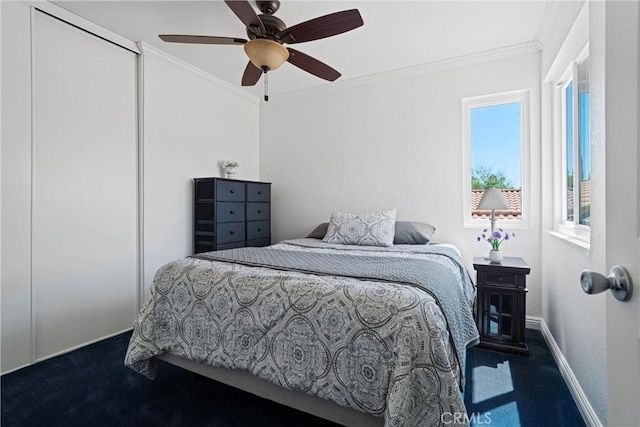 bedroom featuring a ceiling fan, baseboards, ornamental molding, and dark carpet