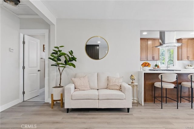 living room featuring baseboards and light wood-type flooring