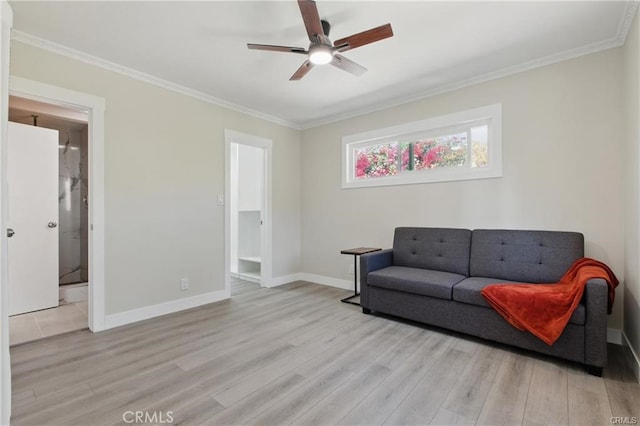 living area with crown molding, ceiling fan, baseboards, and light wood finished floors