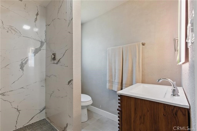 bathroom with toilet, a marble finish shower, and vanity