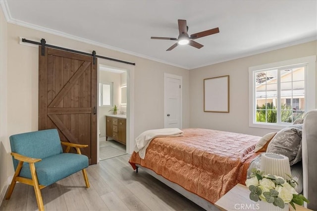 9951 Glencrest Cir, Sun Valley, CA 91504 - bedroom with a barn door, light wood-style flooring, ornamental molding, multiple windows, and ensuite bathroom