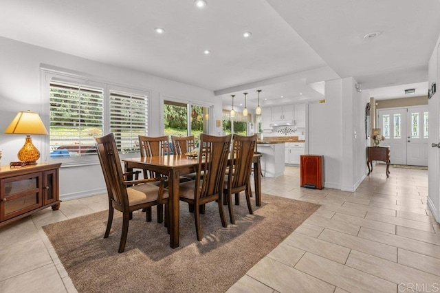 dining space with recessed lighting and light tile patterned floors