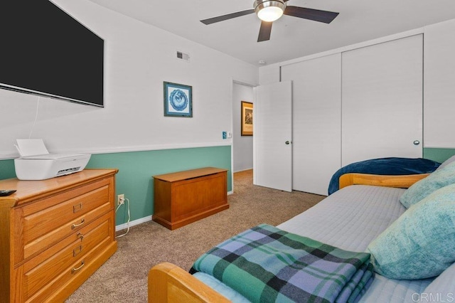 bedroom with ceiling fan, light carpet, a closet, and visible vents