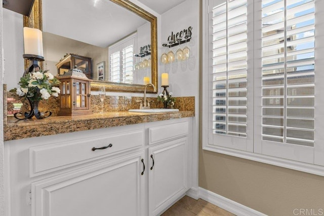 bathroom featuring baseboards and vanity