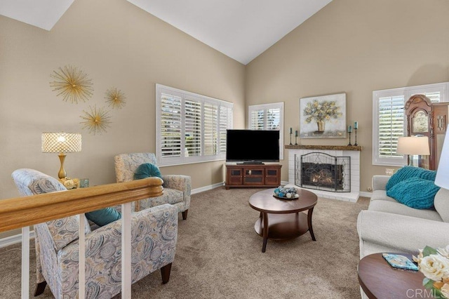 carpeted living room with baseboards, high vaulted ceiling, a healthy amount of sunlight, and a fireplace