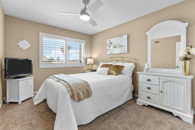 carpeted bedroom featuring visible vents, a ceiling fan, and baseboards