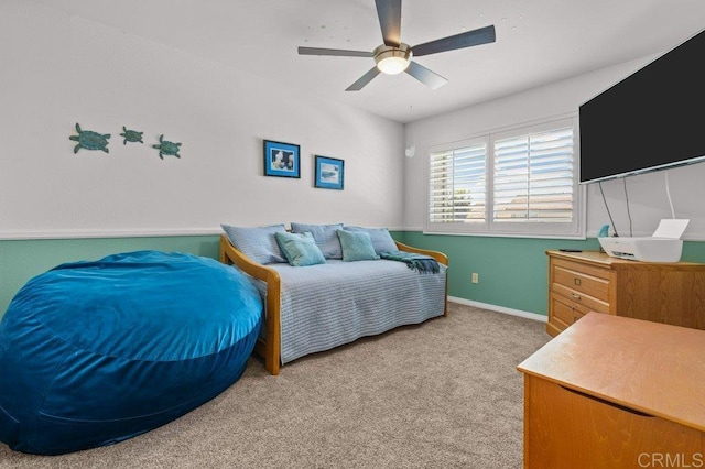 bedroom with baseboards, a ceiling fan, and light carpet