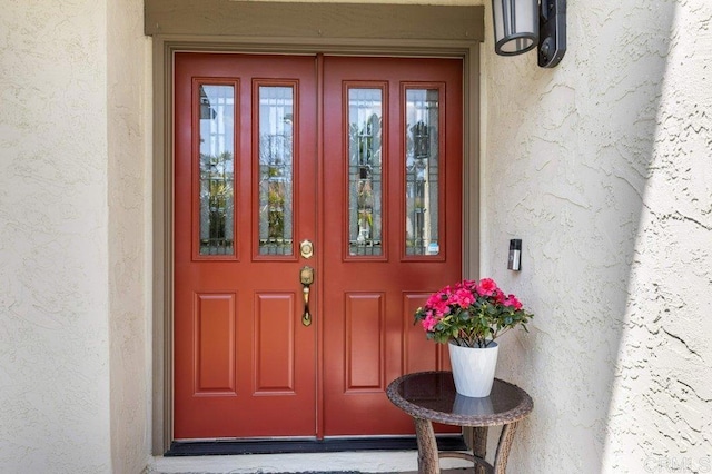 property entrance with stucco siding